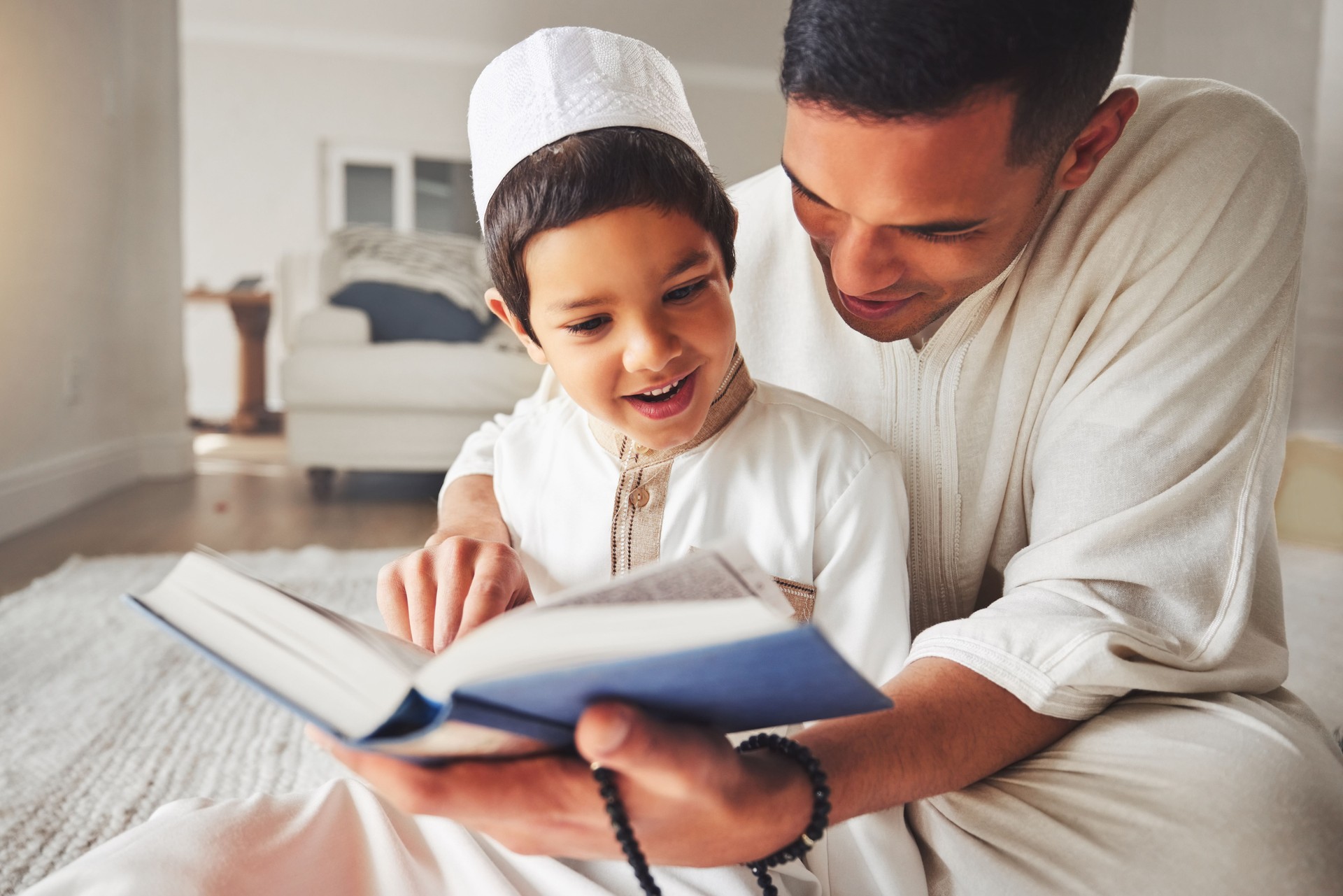Quran, Muslim dad or happy child praying for worship, muslim pray and faith in Allah, god or holy spirit. Child development, home family or Islam father teaching boy, study and reading spiritual book