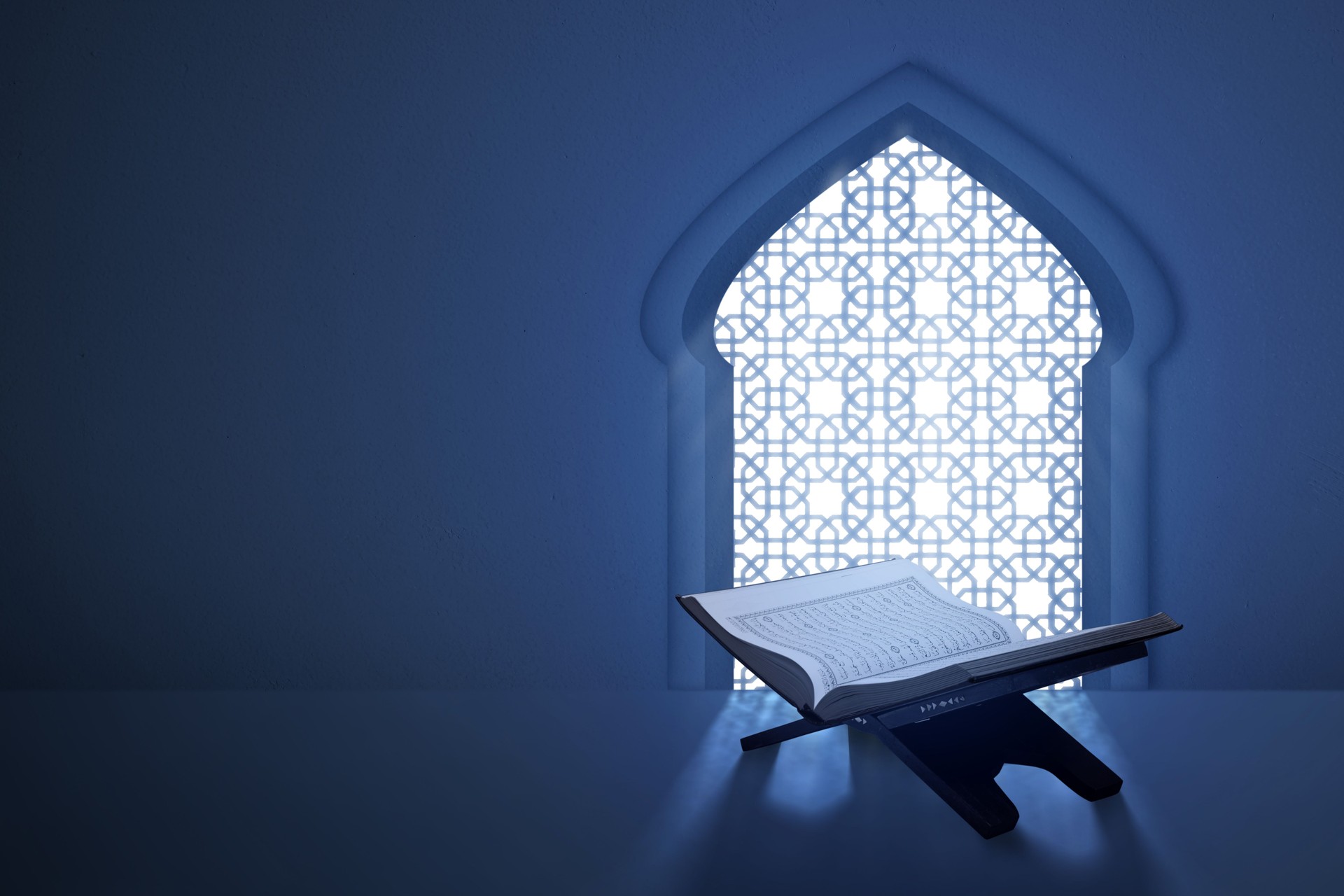 The opened holy book of Al Quran sitting with mosque window on the background. Muslim holy book